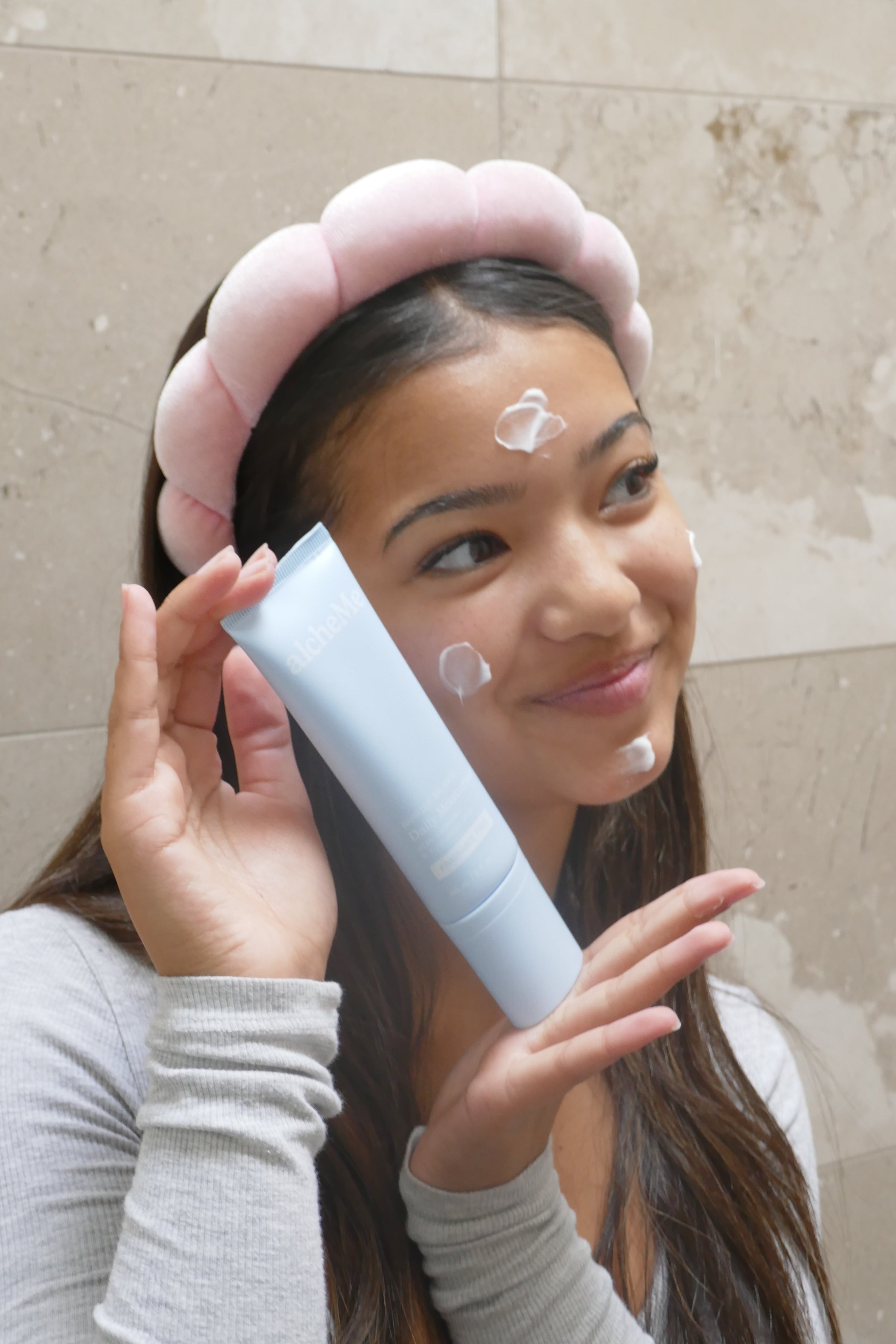 Teen applying alcheMe ceramide moisturiser to face — skin barrier care for teens and tweens aged 9 to 17